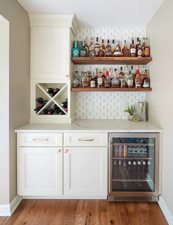 Kitchen bar, warm white cabinets, marble quartz counters, brass hardware, floating wood shelves