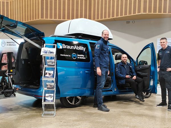 Mobility in Motion showcasing adapted vehicle in exhibition hall.