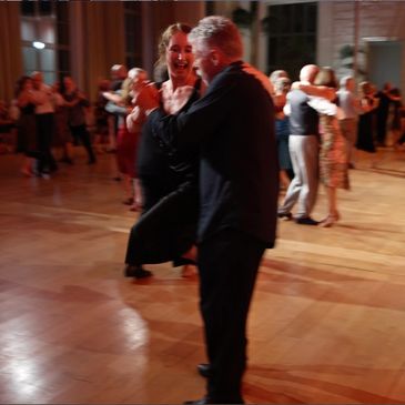 Couples dancing Argentine tango at a milonga in the Colchester tango community after tango lessons and tango workshops.
