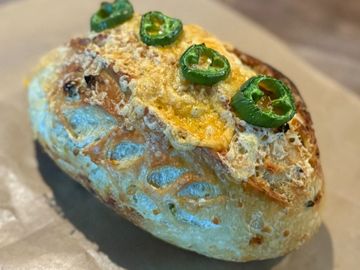 A golden, rustic loaf baked with spicy jalapeños and rich cheddar for the perfect savory kick.