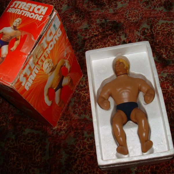 A stretch armstrong doll lies in its packaging, looking all weird and rubbery.