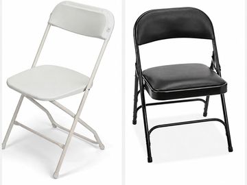 Two folding chairs, one white and one black.