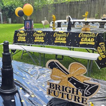 Graduation party setup with balloons and congratulatory decorations.