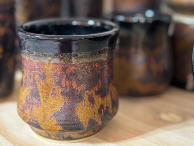 Handcrafted stoneware cup with autumn leaf-inspired glaze and earthy, browns and gold by Kathy Johns