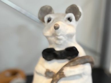 Handcrafted ceramic sculpture of a white mouse, wearing a black bowtie by Daphne Tate, inspired by a