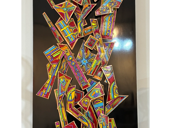 Wall hanging artwork on a black background featuring an artist, modern design with a regular colorfu