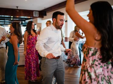 People dancing and socializing at a lively indoor event.