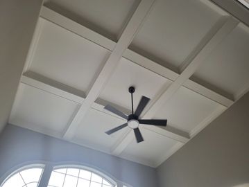 Decorative ceiling, coffer ceiling, wood trim, crown molding, white trim, interior trim, wood beams