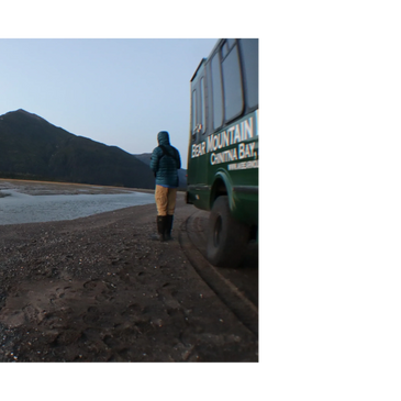 Bear Viewing Bear Mountain Lodge 4x4 bus conversion on beach Alaska mountains