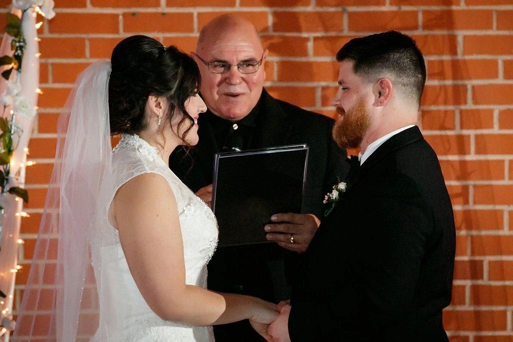 Officiant performing a wedding ceremony indoors.