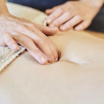 Physio assessing abdomen