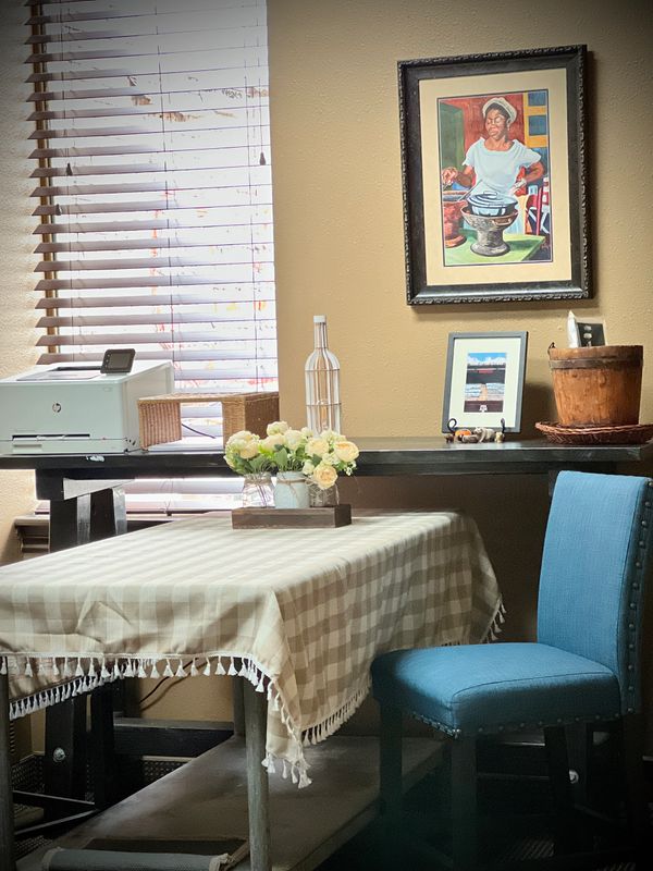 Shared room with a printer, picture frame, table, and chair.