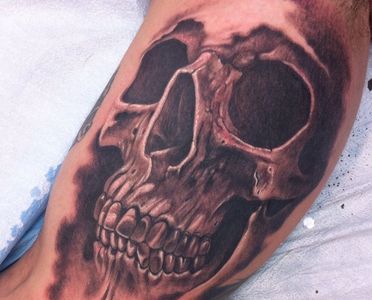Excellent black and grey skull tattoo by Droopy