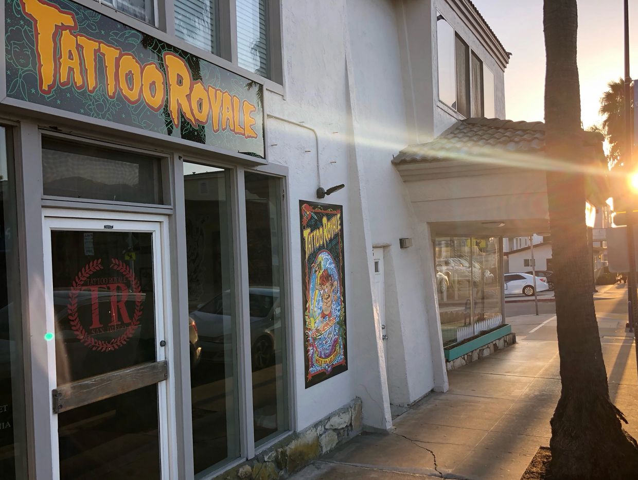 Tattoo Royale’s store front on palm tree lined street in pacific beach, San Diego,CA