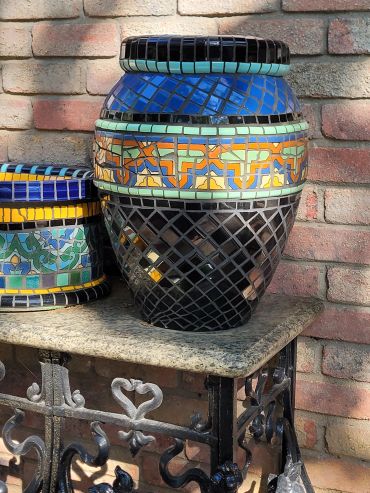 Handcrafted terracotta planter featuring antique Malibu tile with geometric mosaic patterns and Mediterranean-inspired design.