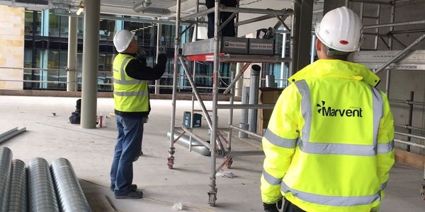Workers installing a ventilation system