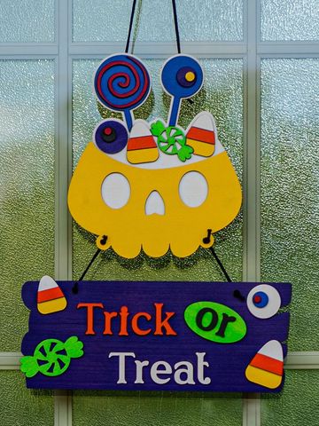 Colorful Halloween "Trick or Treat" door decoration with candy and skull.