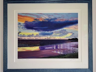 An original print with a mount set in a hand-stained wood frame.