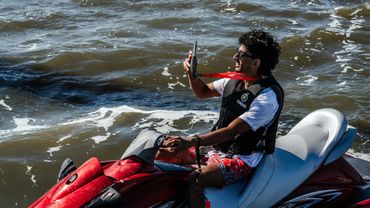 jet ski rider holding a waterproof phone holder