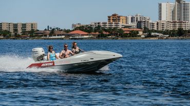 3 people on a speed boat