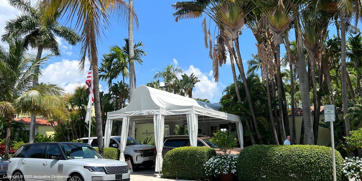Entrance to the Brazilian Court Hotel and condominiums in Palm Beach. White awning and flowers