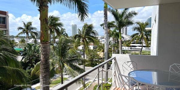 View from balcony through the palm trees, 455 Australian Ave., Palm Beach, condo for sale