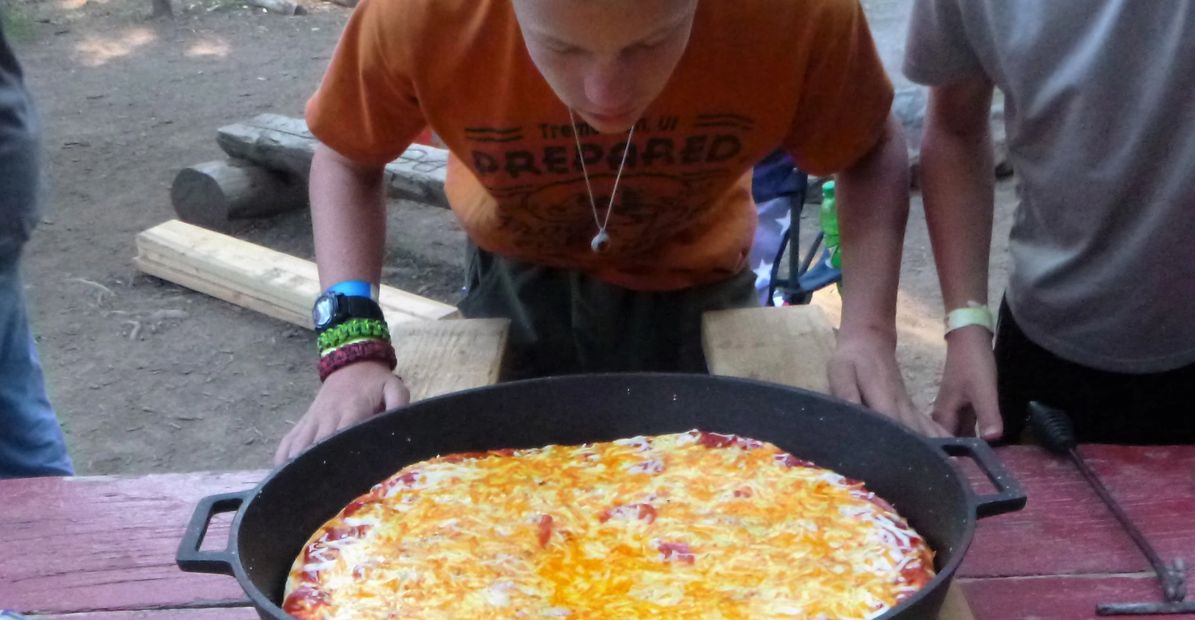 Cast Iron Skillet Boy Scout eating  Pizza
