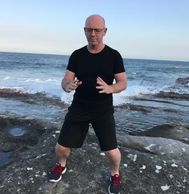 Build the Ball Qi Gong posture in front of ocean. Tai Chi Chuan, Taijiquan. Zhan Zhuang. standing