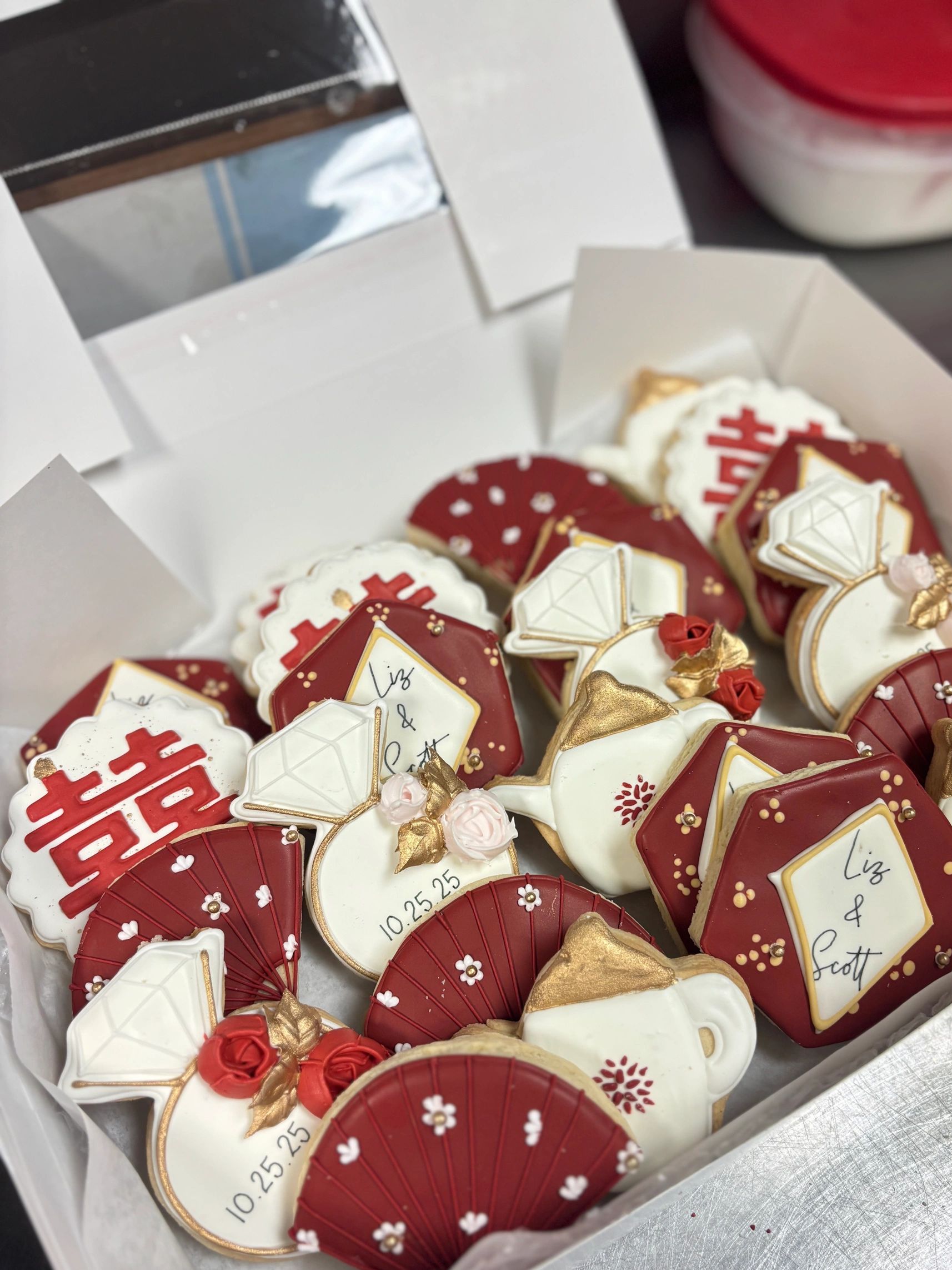 Decorated cookies with wedding and Asian-inspired designs.