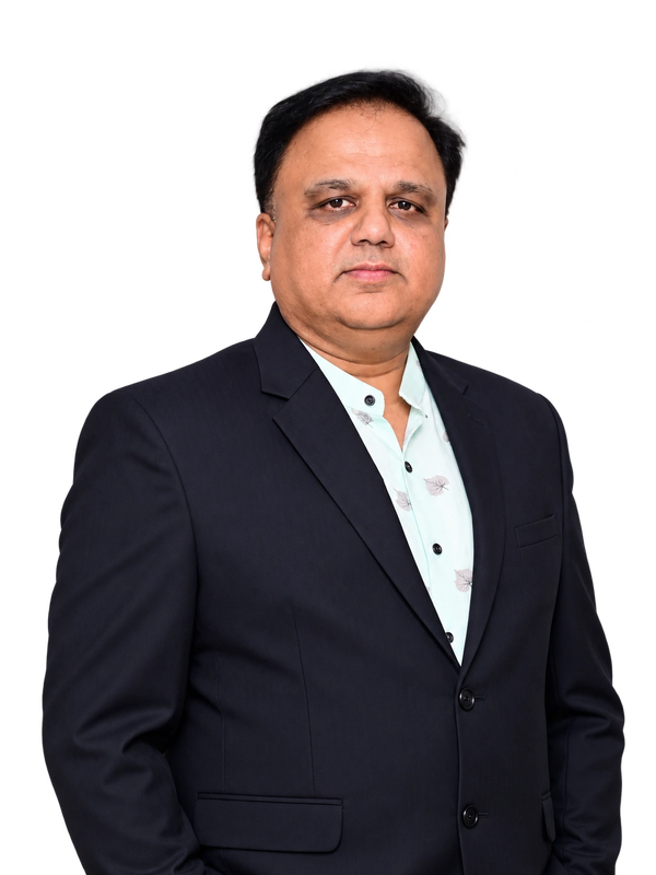 Man in formal suit posing confidently.