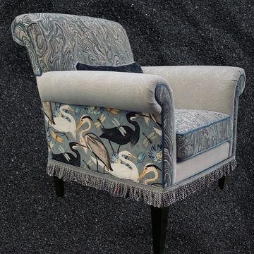 a gray color chair with birds print on it