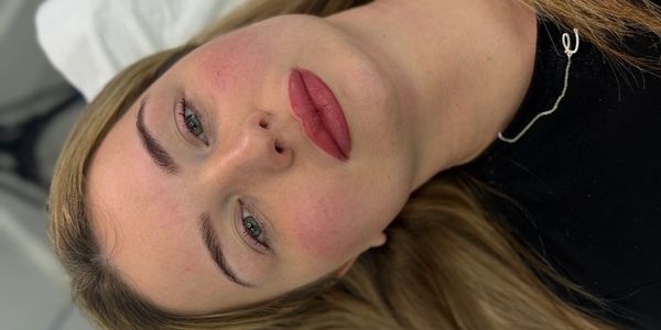 Close-up of a woman's face with makeup, lying down.