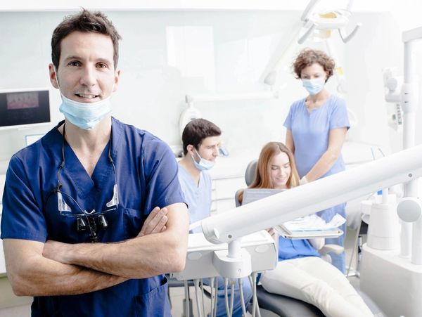 Portrait of dentists standing in modern medical office