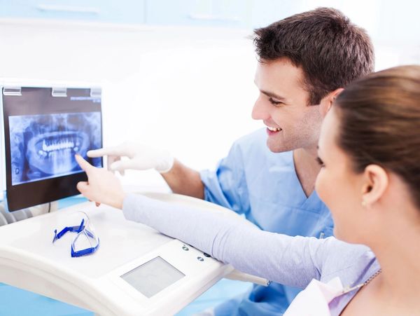 Dentist explaining x ray picture to patient