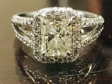 Elegant diamond engagement ring with a rectangular center stone.