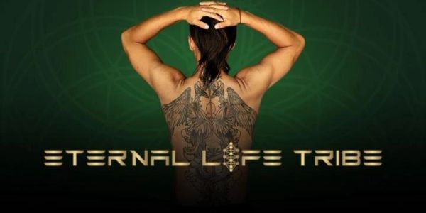 Muscular tattooed back with "Eternal Life Tribe" text.