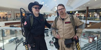 Two people dressed as Ghostbusters in a mall.