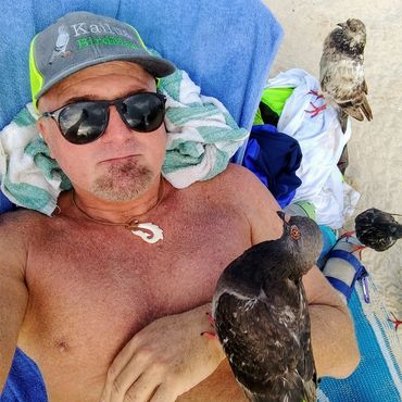 Birdman napping with pigeons