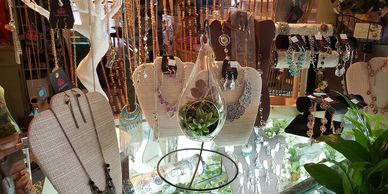 Display of various necklaces and jewelry on stands in a shop.