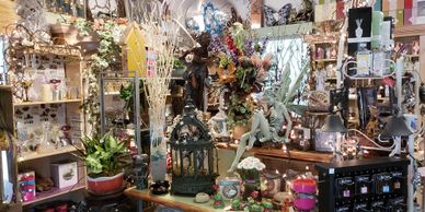 A cluttered shop filled with eclectic decorative items and plants.