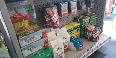 Shelf displaying various gardening and plant care products.