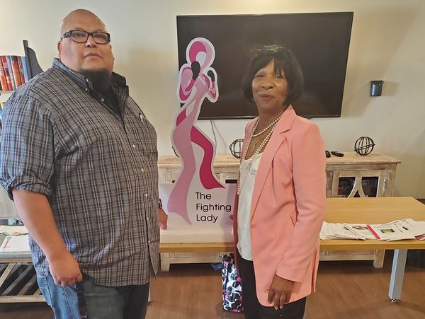 A man and a woman inside a room with television