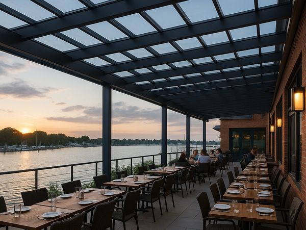 Waterfront restaurant with glass pergola and sunset marina dining.
