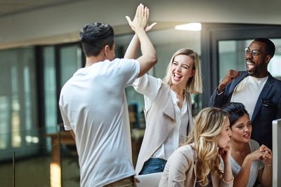 Professionals celebrating during a team meeting