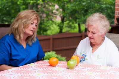 Two women having a conversation at an outdoor table