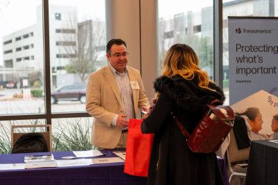 Tristate Financial Network representative speaking with a visitor about insurance options