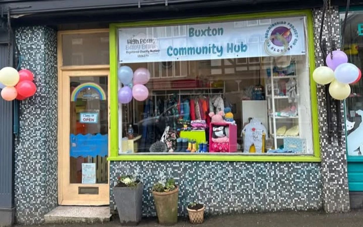 Front view of Buxton Community Hub with colorful balloons and a welcoming entrance.