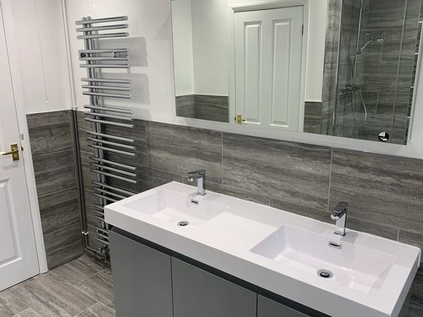 Twin sink, illuminated mirror, tiles and designer radiator