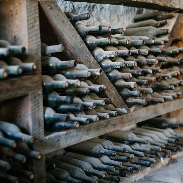 A wine cellar with dusty wine bottles