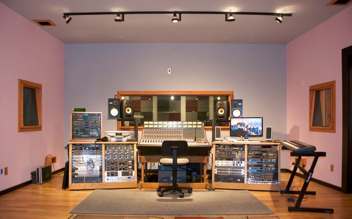 Professional recording studio with mixing console and keyboard.